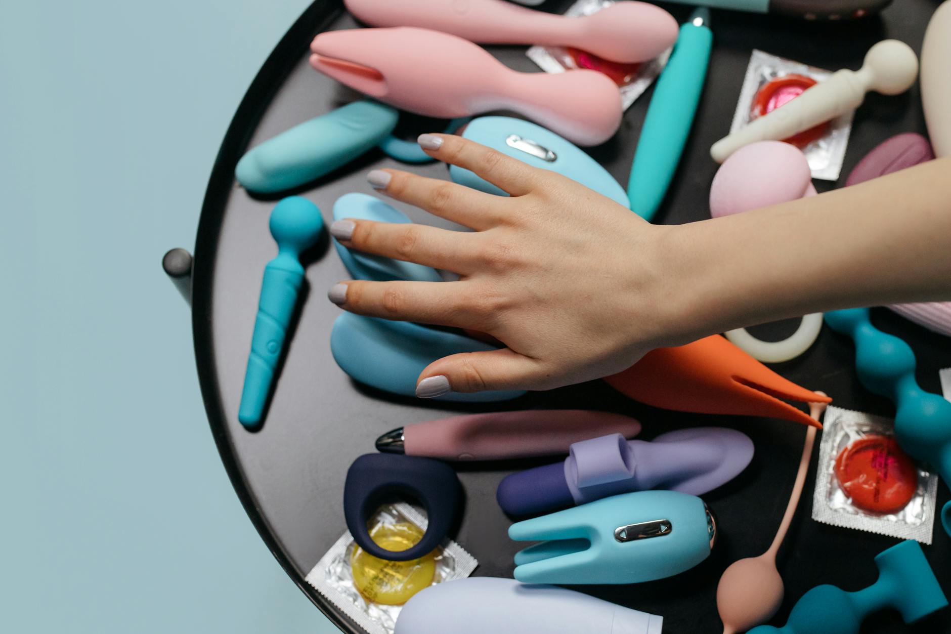 Close-up of colorful sex toys arranged on a surface, representing intimate tools for couples exploring together